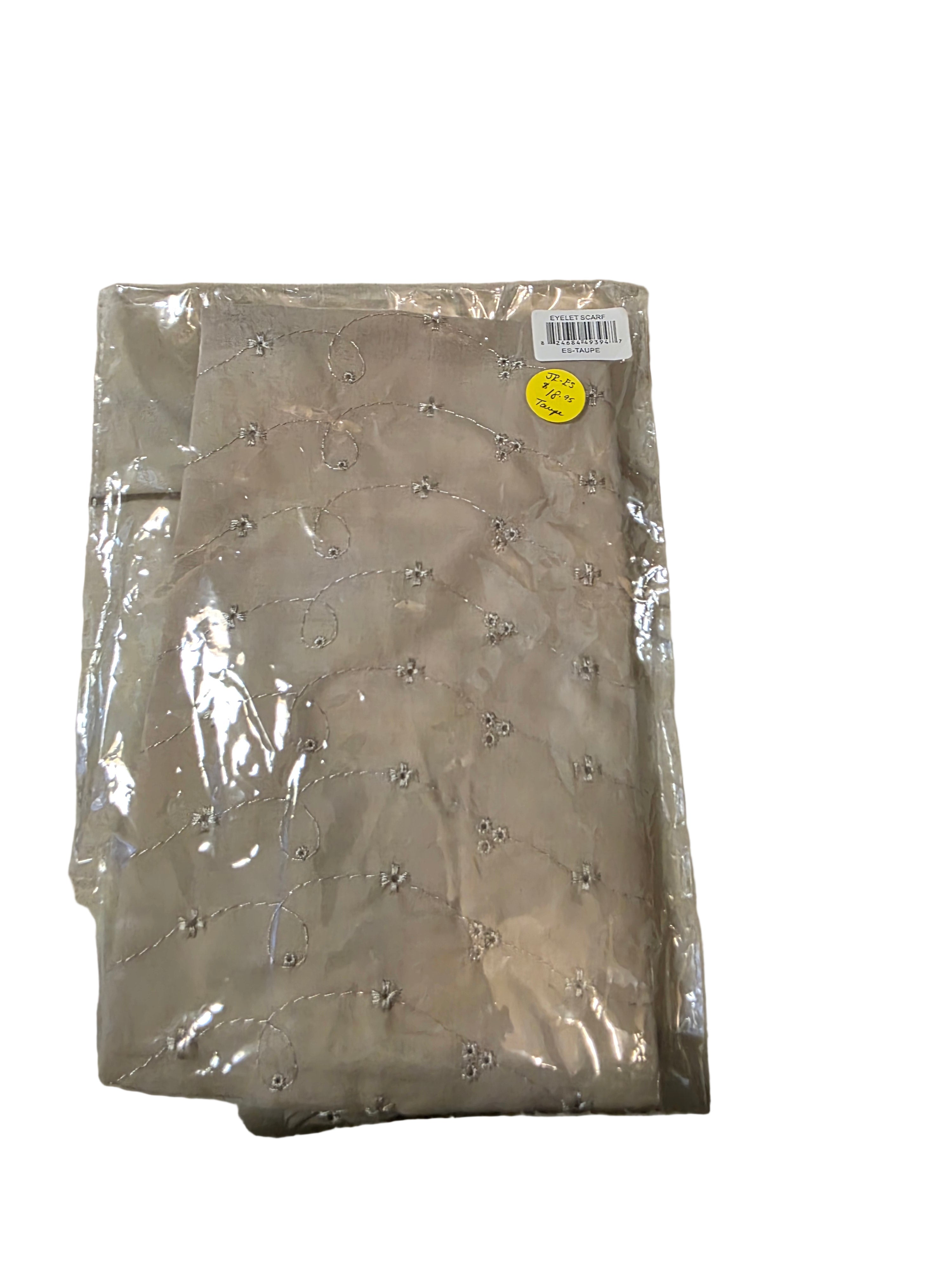 Packaged beige fabric with rhinestone pattern on a beige background
