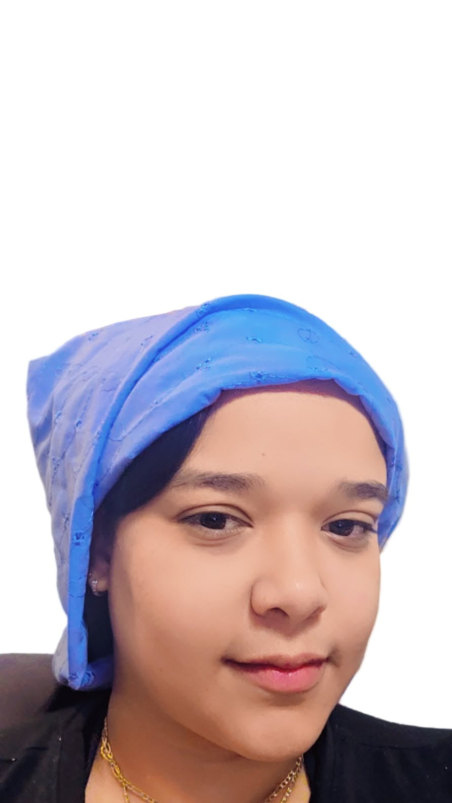 Person wearing a blue headscarf with a decorative painting in the background